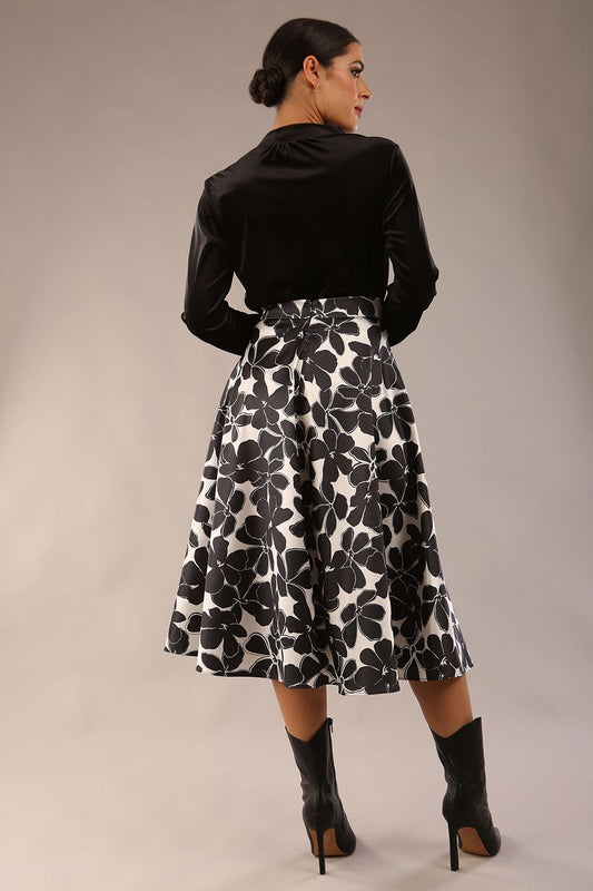 model is wearing a Gwendolyn Midi Length Skirt in Floral Print satin black and white a-line midi length skirt