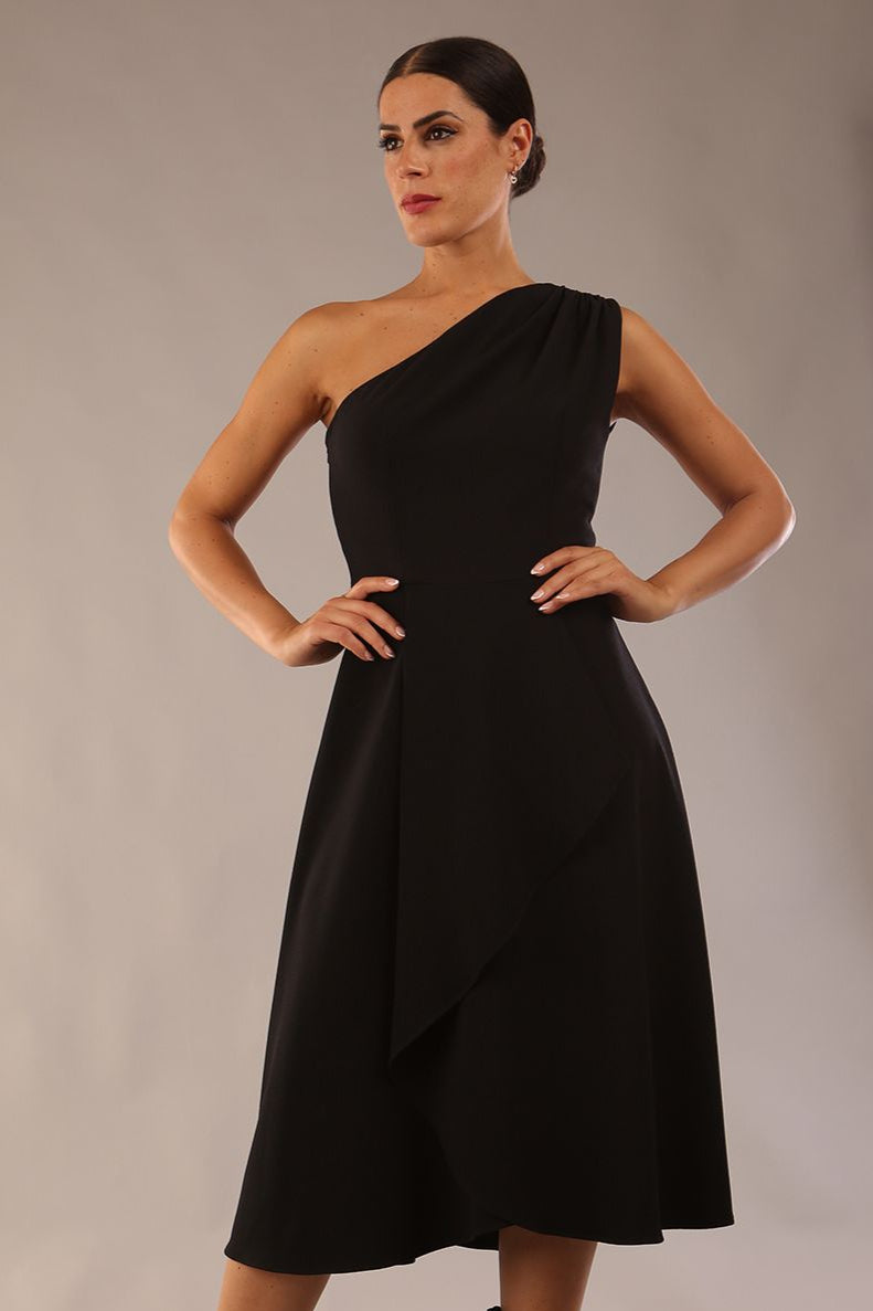 Model wearing a diva catwalk Portia One Shoulder A-line Dress midi length sleeveless style in Black Colour