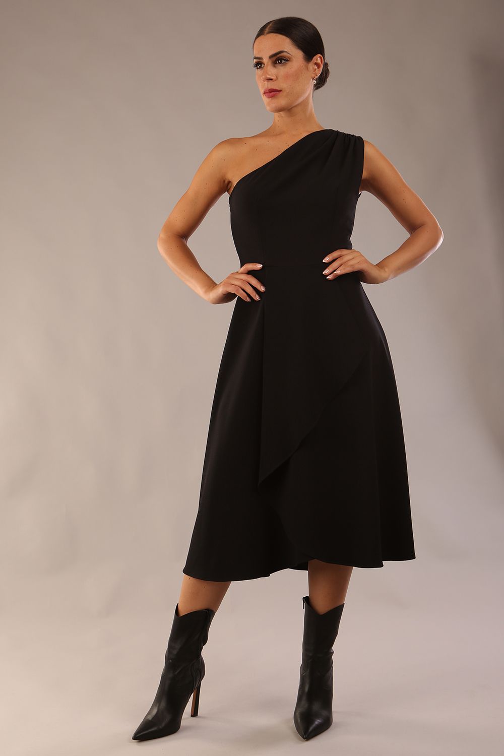 Model wearing a diva catwalk Portia One Shoulder A-line Dress midi length sleeveless style in Black Colour