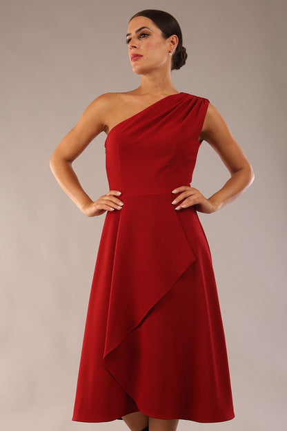 Model wearing a diva catwalk Portia One Shoulder A-line Dress midi length sleeveless style in Rosewood Red Colour