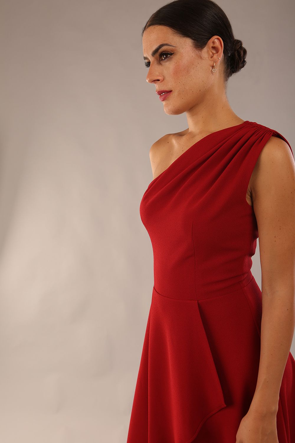 Model wearing a diva catwalk Portia One Shoulder A-line Dress midi length sleeveless style in Rosewood red Colour