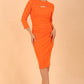 Model wearing a Clementine Keyhole Sleeved Pencil Dress in Golden Poppy colour