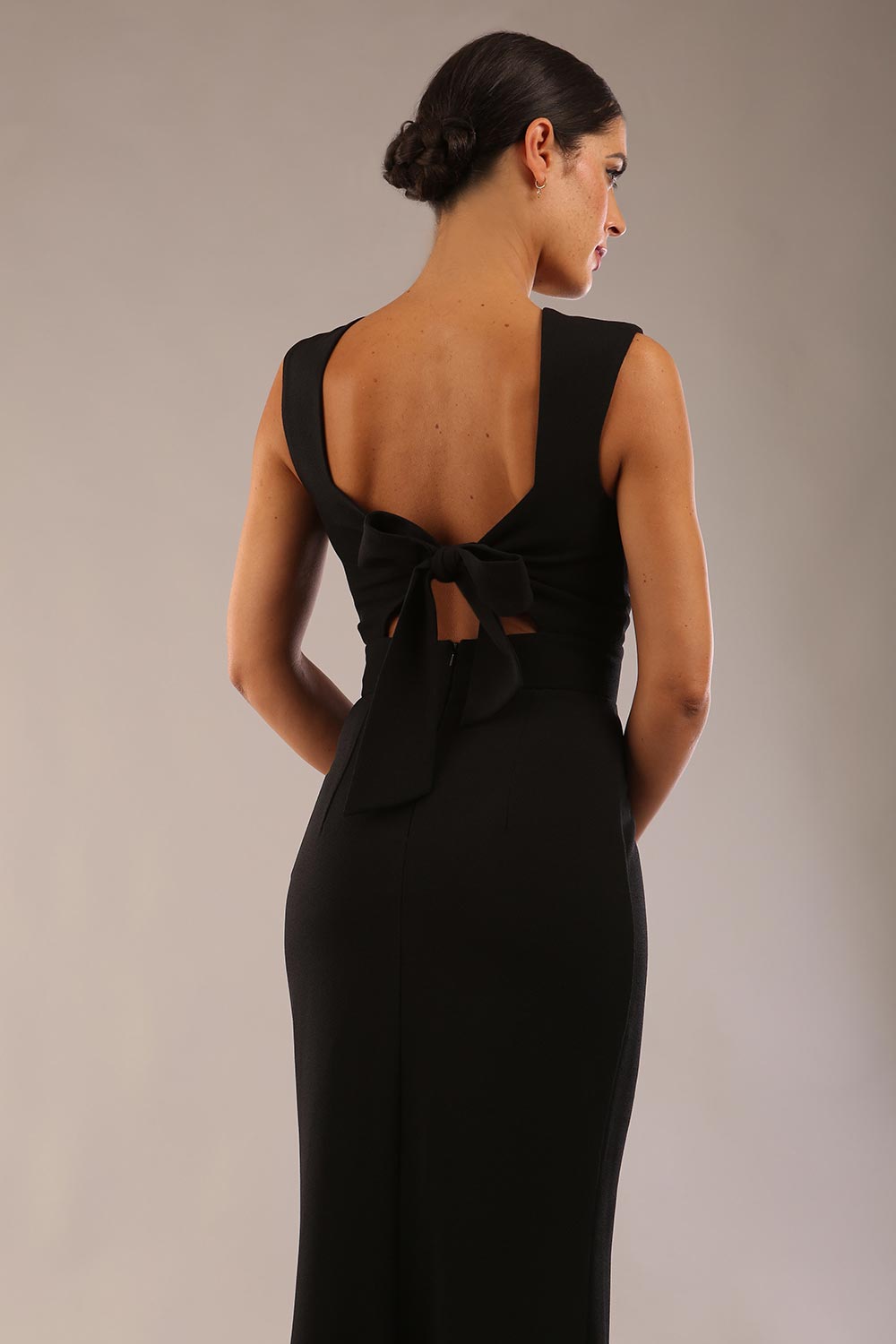 model wearing a diva catwalk Morwenna Keyhole Full Length Dress sleeveless style with keyhole detail at front in Black colour