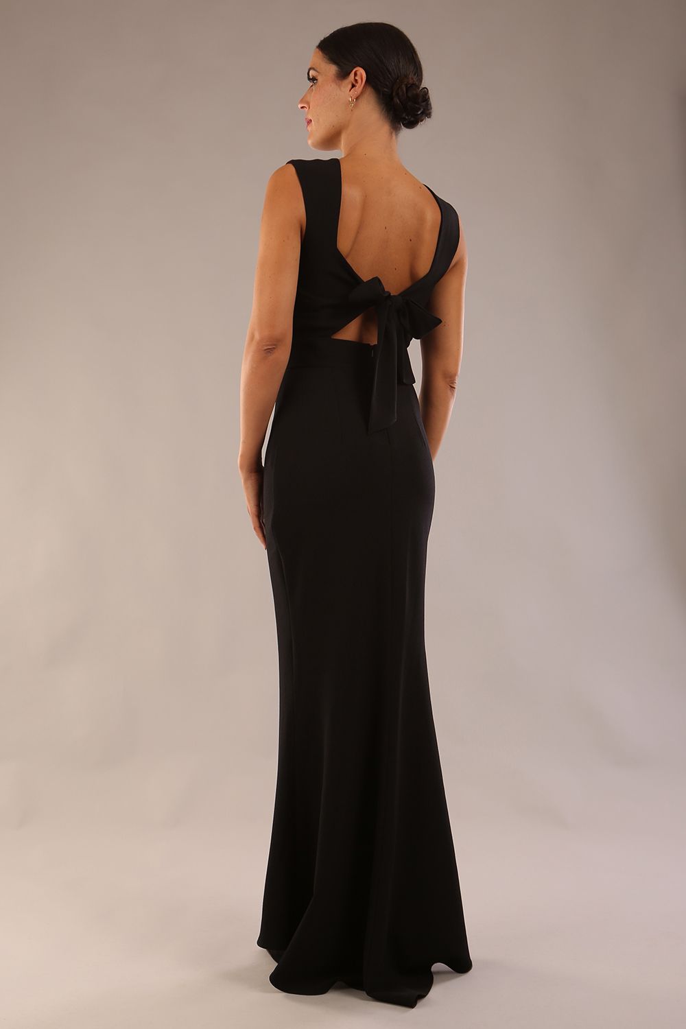 model wearing a diva catwalk Morwenna Keyhole Full Length Dress sleeveless style with keyhole detail at front in Black colour