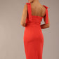 brunette model wearing a diva catwalk Philippa Pencil Wiggle Dress sleeveless style, tie detail on the shoulders knee length and sweetheart neckline in grenadine orange colour back