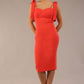 brunette model wearing a diva catwalk Philippa Pencil Wiggle Dress sleeveless style, tie detail on the shoulders knee length and sweetheart neckline in grenadine orange colour front