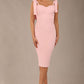 brunette model wearing a diva catwalk Philippa Pencil Wiggle Dress sleeveless style, tie detail on the shoulders knee length and sweetheart neckline in crystal pink colour front 