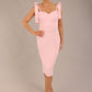 brunette model wearing a diva catwalk Philippa Pencil Wiggle Dress sleeveless style, tie detail on the shoulders knee length and sweetheart neckline in crystal pink colour front with hat
