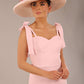 brunette model wearing a diva catwalk Philippa Pencil Wiggle Dress sleeveless style, tie detail on the shoulders knee length and sweetheart neckline in crystal pink colour front with hat