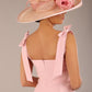 brunette model wearing a diva catwalk Philippa Pencil Wiggle Dress sleeveless style, tie detail on the shoulders knee length and sweetheart neckline in crystal pink colour back with hat