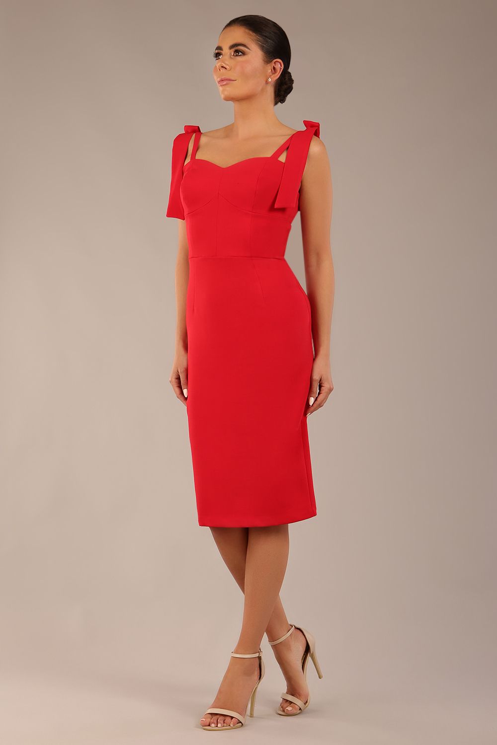 brunette model wearing a diva catwalk Philippa Pencil Wiggle Dress sleeveless style, tie detail on the shoulders knee length and sweetheart neckline in scarlet red colour front 