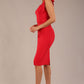 brunette model wearing a diva catwalk Philippa Pencil Wiggle Dress sleeveless style, tie detail on the shoulders knee length and sweetheart neckline in scarlet red colour front side