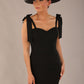 brunette model wearing a diva catwalk Philippa Pencil Wiggle Dress sleeveless style, tie detail on the shoulders knee length and sweetheart neckline in black colour front with hat