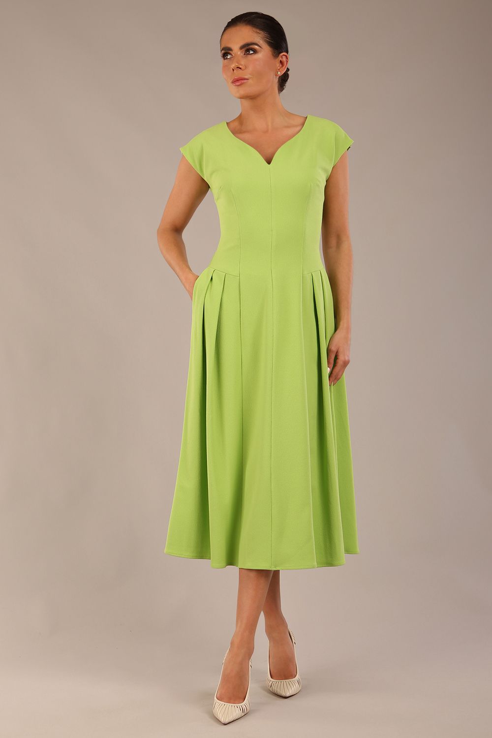 brunette model is wearing a diva catwalk Audrey a-line Dress sweetheart neckline and With Pockets and sleeveless with ankle length in lime green colour front