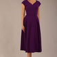 brunette model is wearing a diva catwalk Audrey a-line Dress sweetheart neckline and With Pockets and sleeveless with ankle length in passion purple colour front