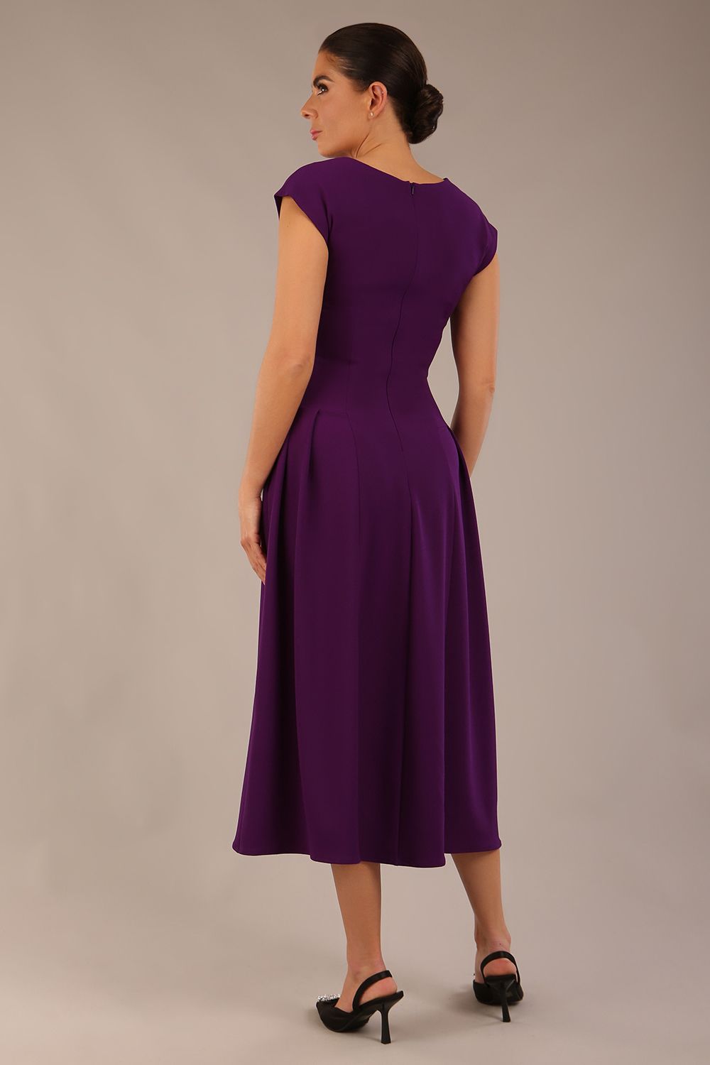brunette model is wearing a diva catwalk Audrey a-line Dress sweetheart neckline and With Pockets and sleeveless with ankle length in passion purple colour back