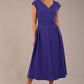 brunette model is wearing a diva catwalk Audrey a-line Dress sweetheart neckline and With Pockets and sleeveless with ankle length inspectrum indigo colour front