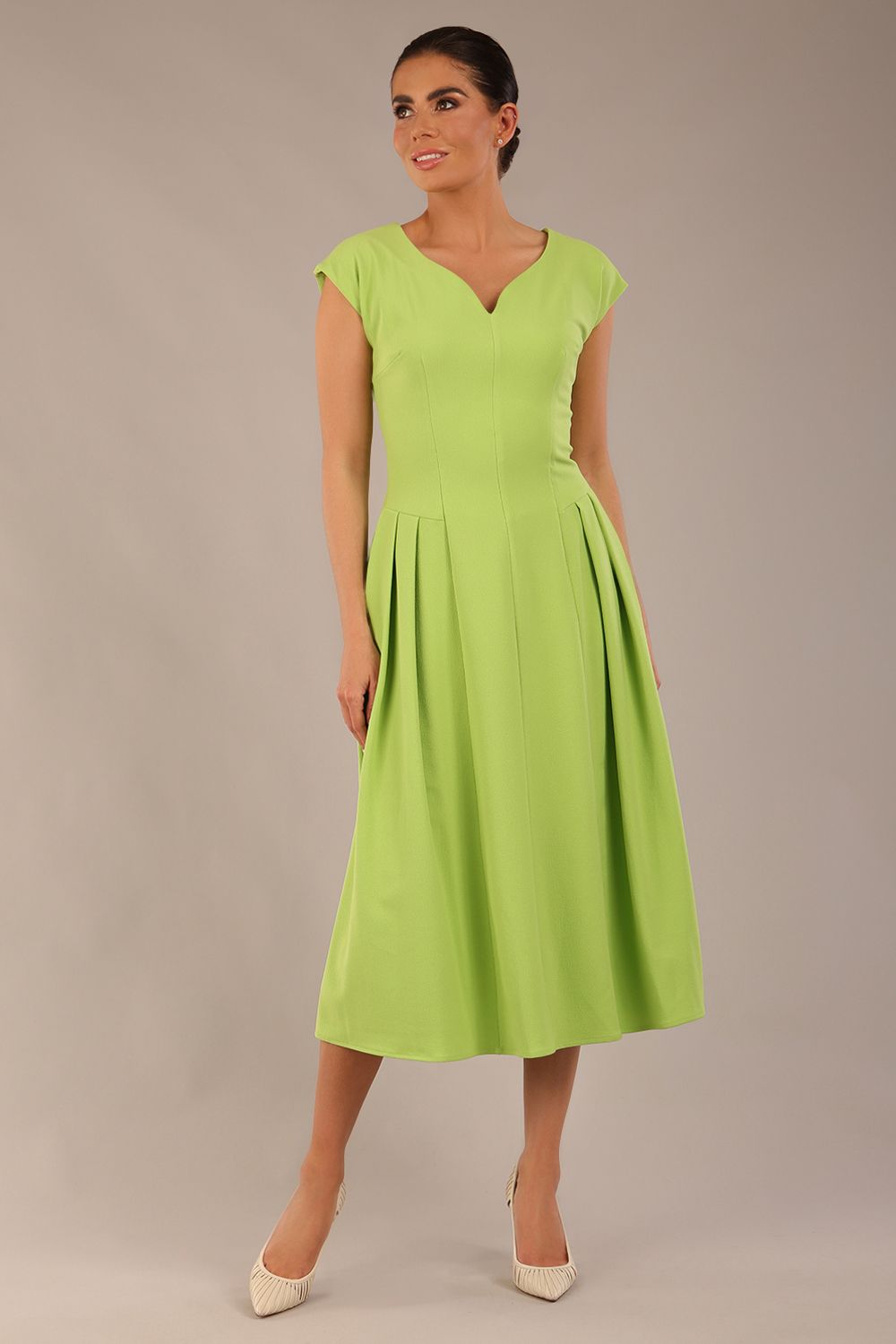 brunette model is wearing a diva catwalk Audrey a-line Dress sweetheart neckline and With Pockets and sleeveless with ankle length in lime green colour front