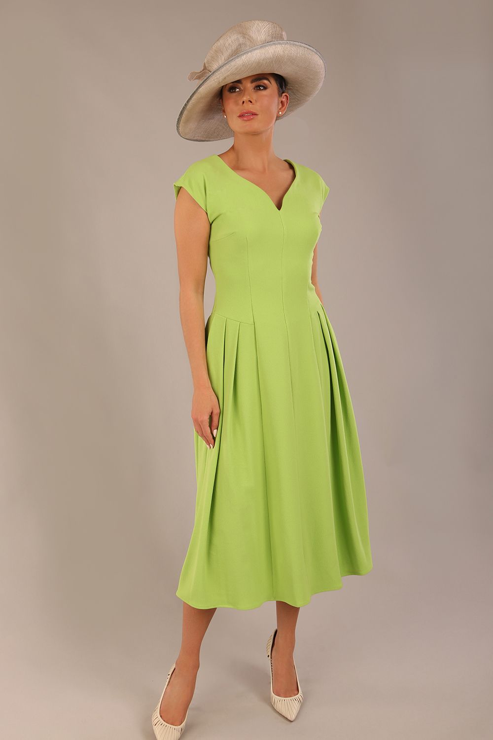 brunette model is wearing a diva catwalk Audrey a-line Dress sweetheart neckline and With Pockets and sleeveless with ankle length in lime green colour