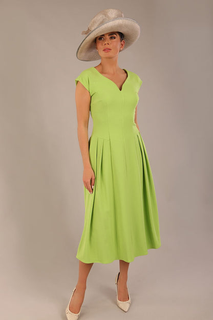 brunette model is wearing a diva catwalk Audrey a-line Dress sweetheart neckline and With Pockets and sleeveless with ankle length in lime green colour