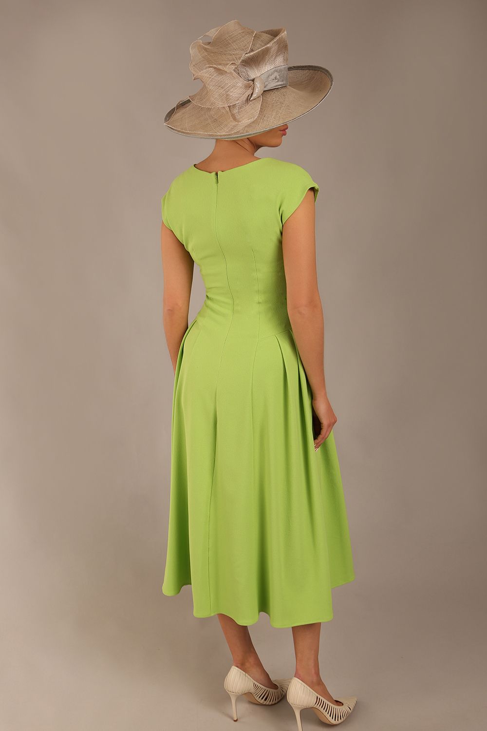brunette model is wearing a diva catwalk Audrey a-line Dress sweetheart neckline and With Pockets and sleeveless with ankle length in lime green colour back