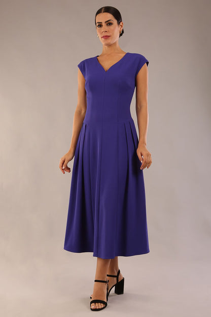 brunette model is wearing a diva catwalk Audrey Dress With Pockets sleeveless and ankle length in spectrum indigo colour