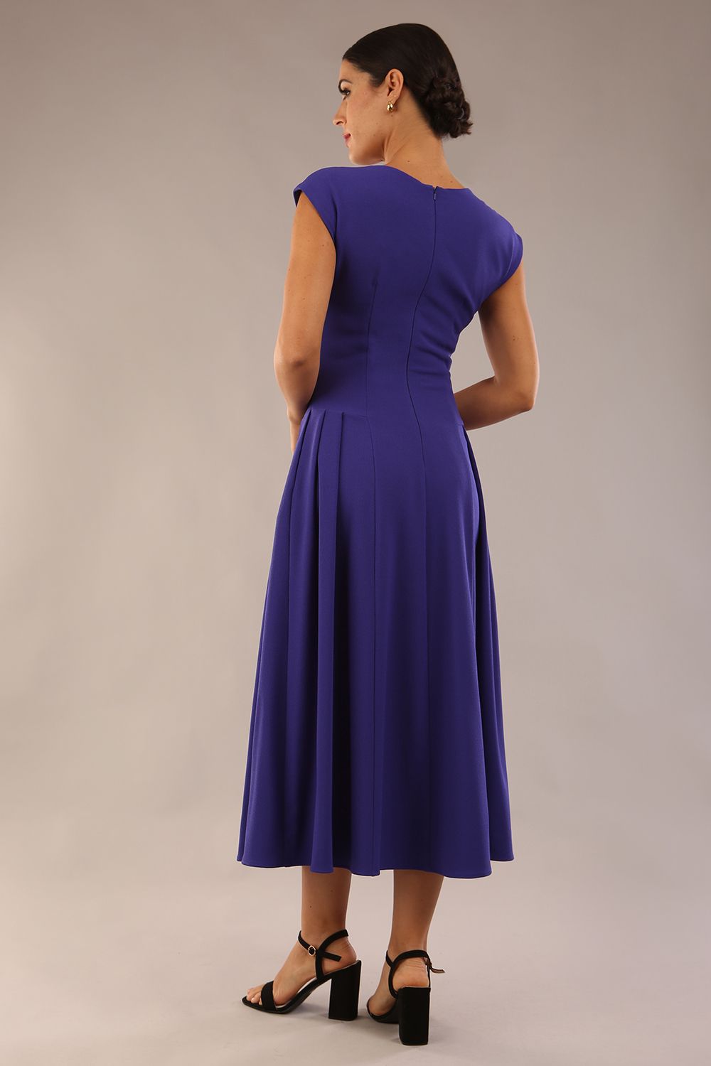 brunette model is wearing a diva catwalk Audrey Dress With Pockets sleeveless and ankle length in spectrum indigo colour back