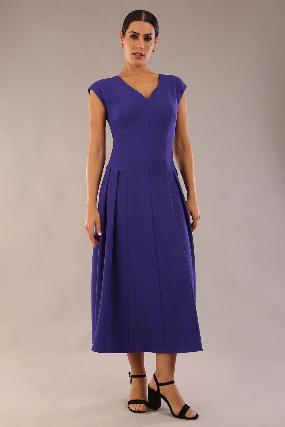 brunette model is wearing a diva catwalk Audrey Dress With Pockets sleeveless and ankle length in spectrum indigo colour