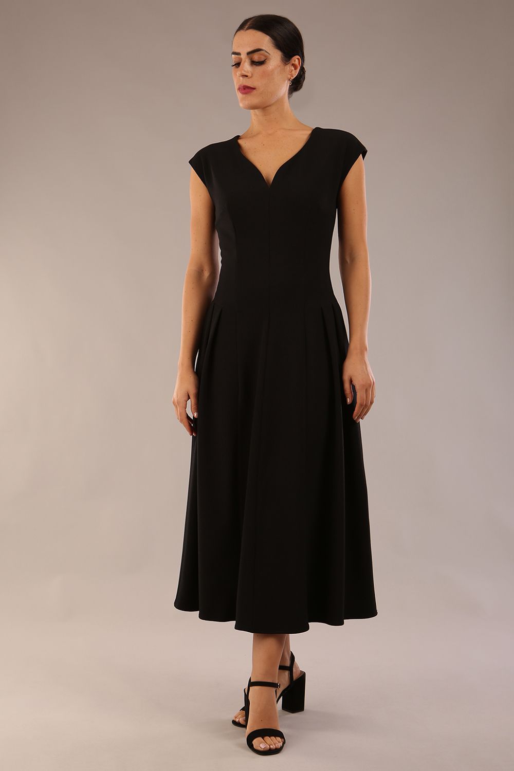 brunette model is wearing a diva catwalk Audrey Dress With Pockets sleeveless and ankle length in black colour