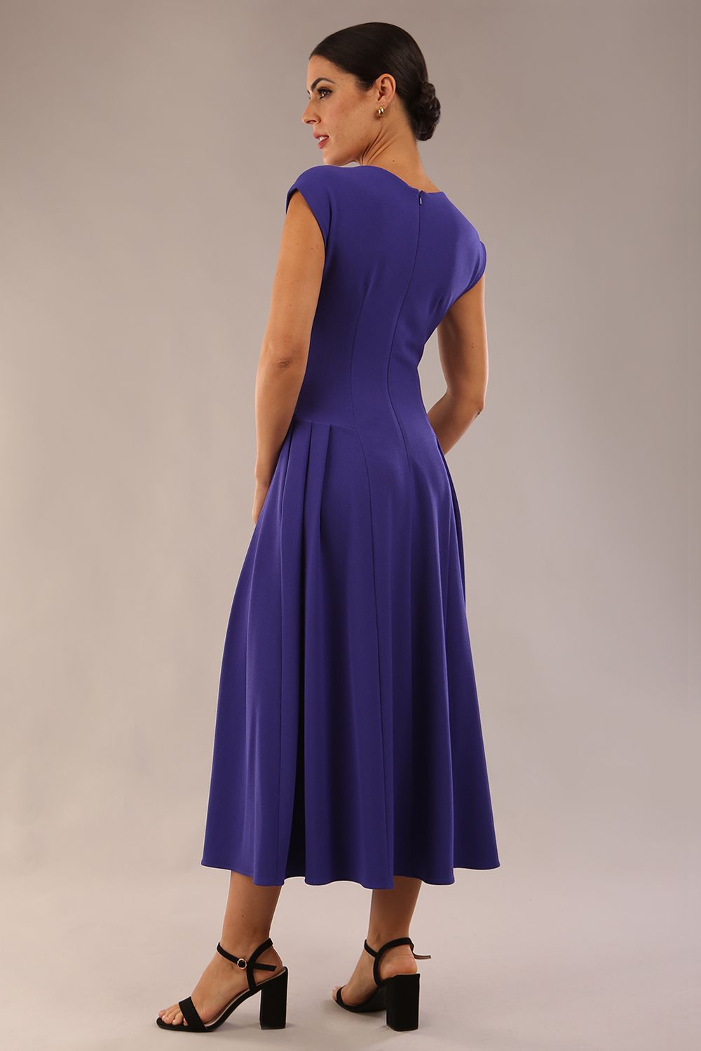 brunette model is wearing a diva catwalk Audrey Dress With Pockets sleeveless and ankle length in spectrum indigo colour