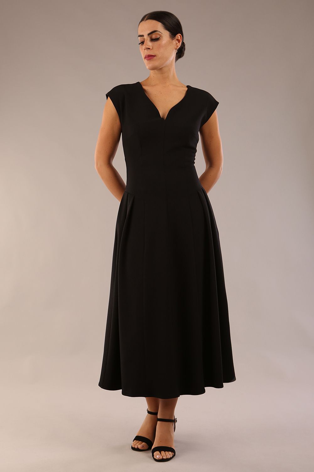 brunette model is wearing a diva catwalk Audrey Dress With Pockets sleeveless and ankle length in black colour