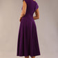 brunette model is wearing a diva catwalk Audrey Dress With Pockets sleeveless and ankle length in passion purple colour