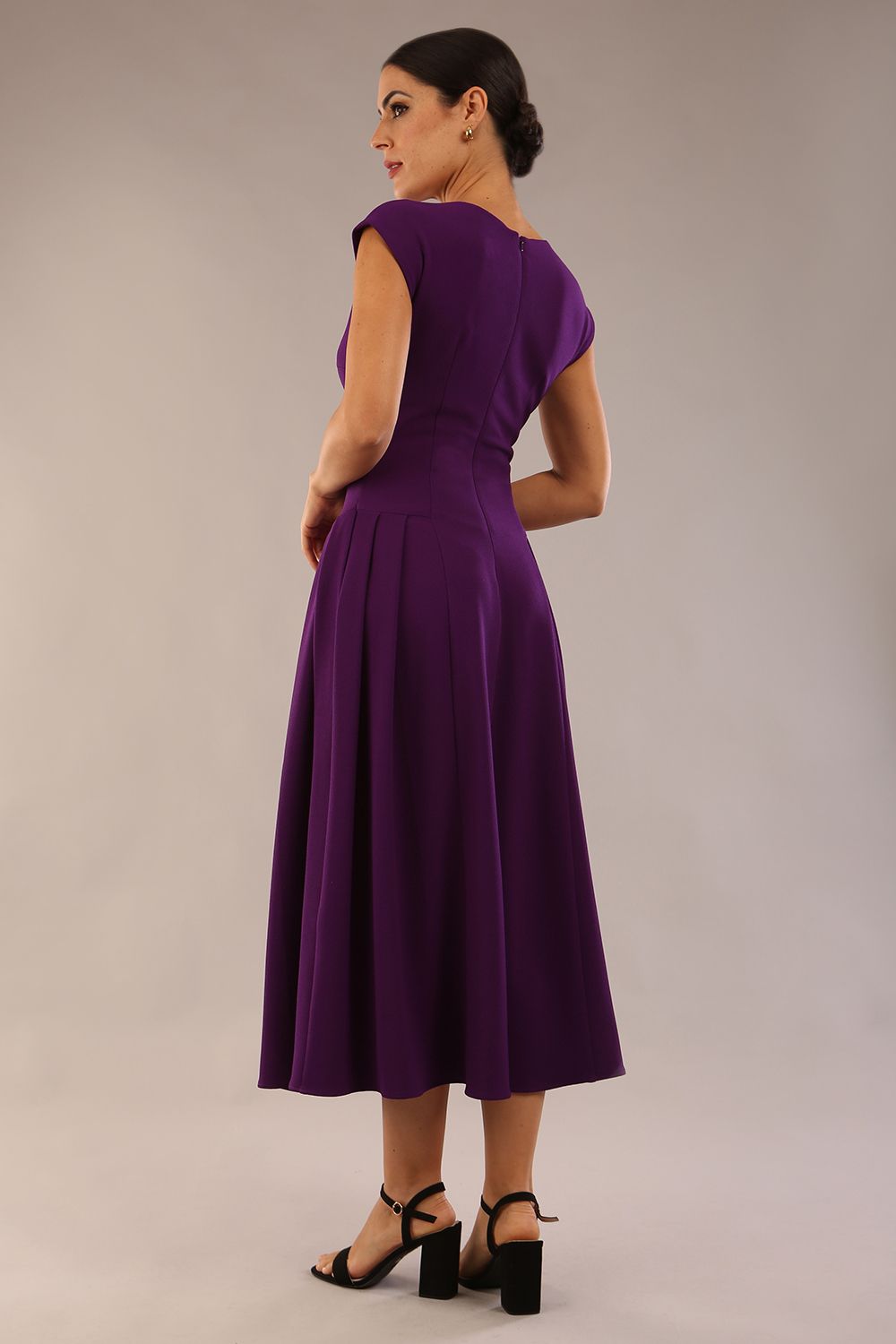 brunette model is wearing a diva catwalk Audrey Dress With Pockets sleeveless and ankle length in passion purple colour