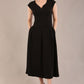 brunette model is wearing a diva catwalk Audrey Dress With Pockets sleeveless and ankle length in black colour