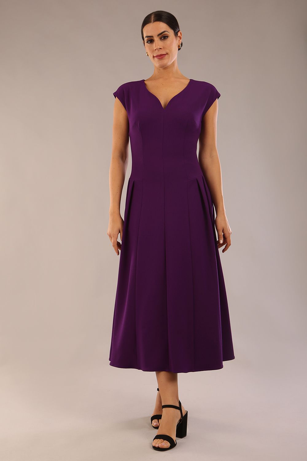 brunette model is wearing a diva catwalk Audrey Dress With Pockets sleeveless and ankle length in passion purple colour