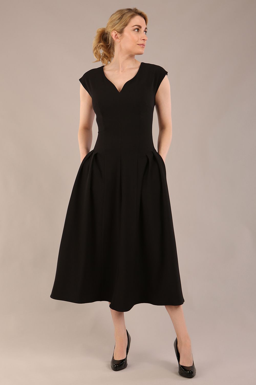 brunette model is wearing a diva catwalk Audrey Dress With Pockets sleeveless and ankle length in black colour