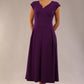 brunette model is wearing a diva catwalk Audrey Dress With Pockets sleeveless and ankle length in passion purple colour