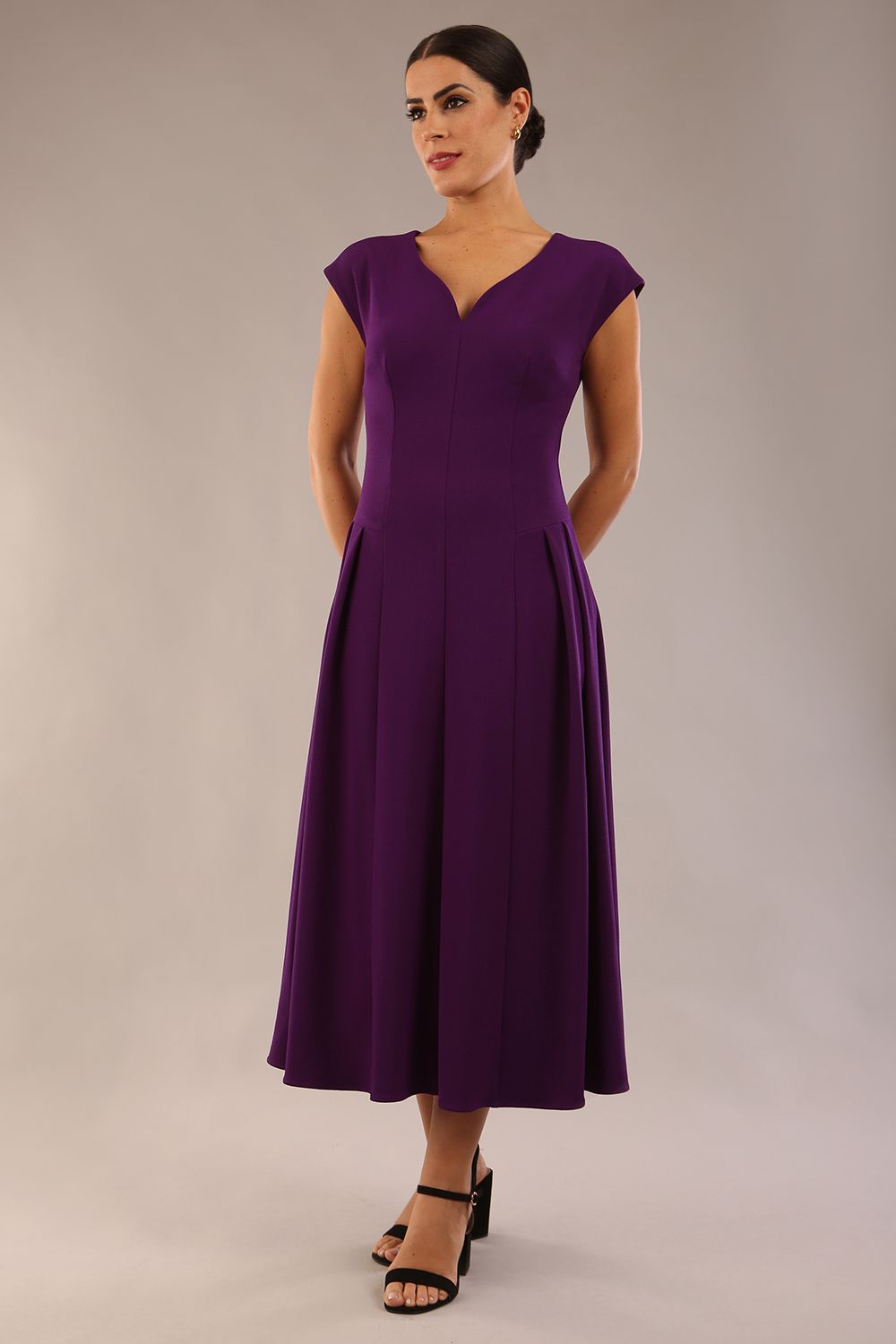 brunette model is wearing a diva catwalk Audrey Dress With Pockets sleeveless and ankle length in passion purple colour