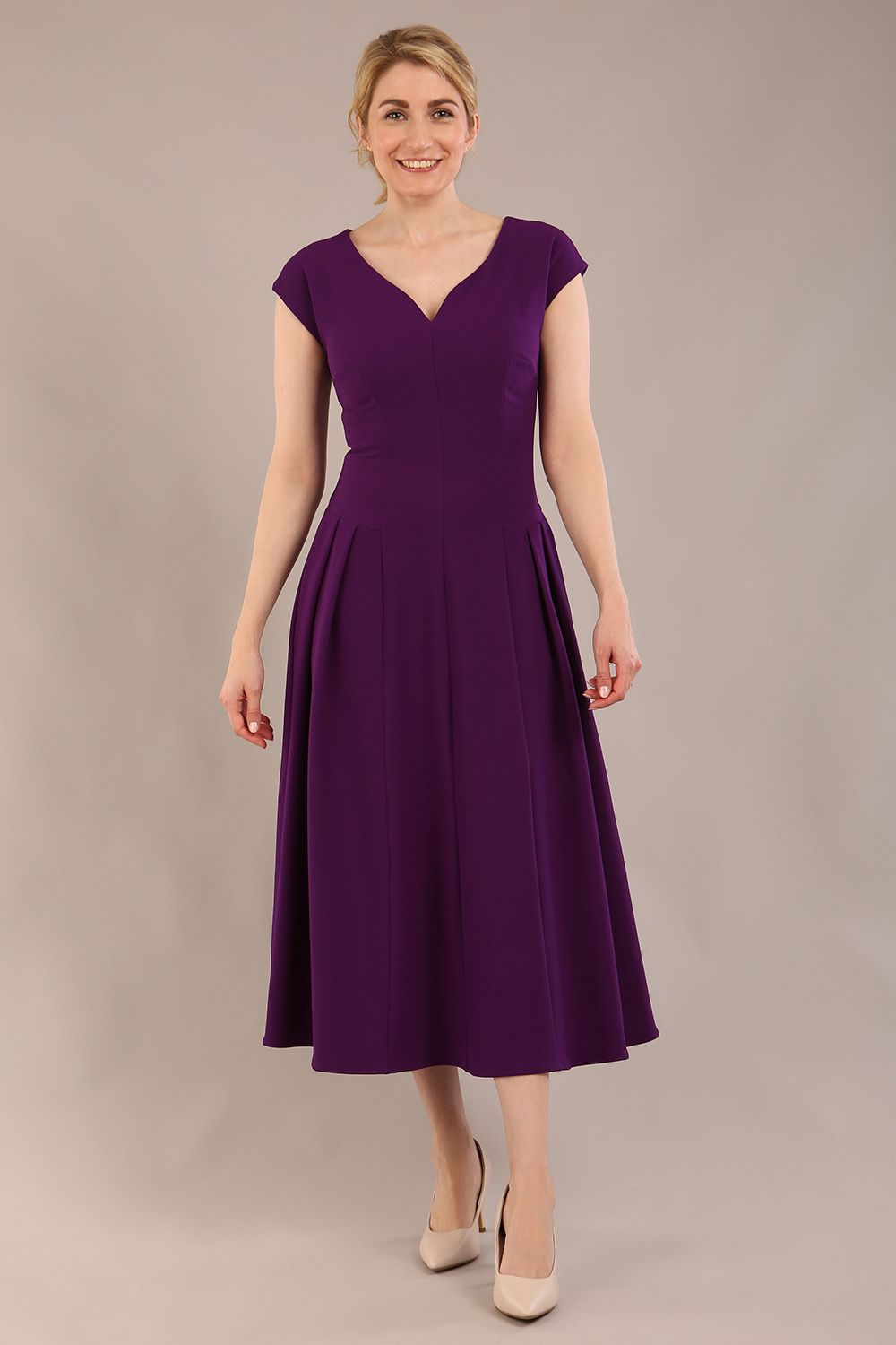 brunette model is wearing a diva catwalk Audrey Dress With Pockets sleeveless and ankle length in passion purple colour