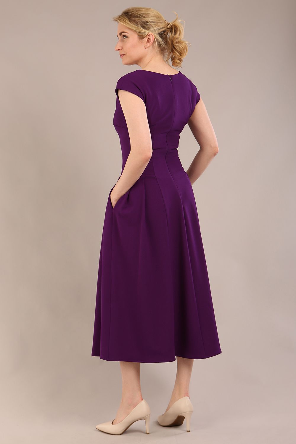 brunette model is wearing a diva catwalk Audrey Dress With Pockets sleeveless and ankle length in passion purple colour