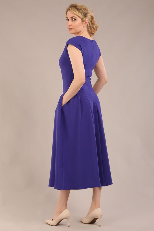 brunette model is wearing a diva catwalk Audrey Dress With Pockets sleeveless and ankle length in spectrum indigo colour