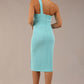 Model wearing a divacatwalk Sofia Pencil Dress knee length front side vent with diagonal halter neck in turquoise colour front