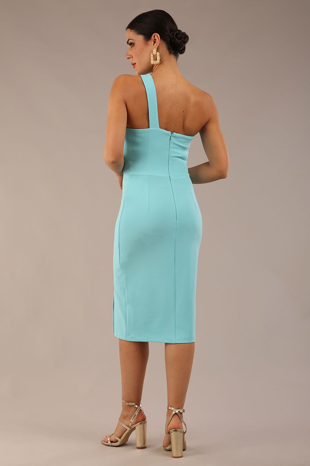 Model wearing a divacatwalk Sofia Pencil Dress knee length front side vent with diagonal halter neck in turquoise colour front