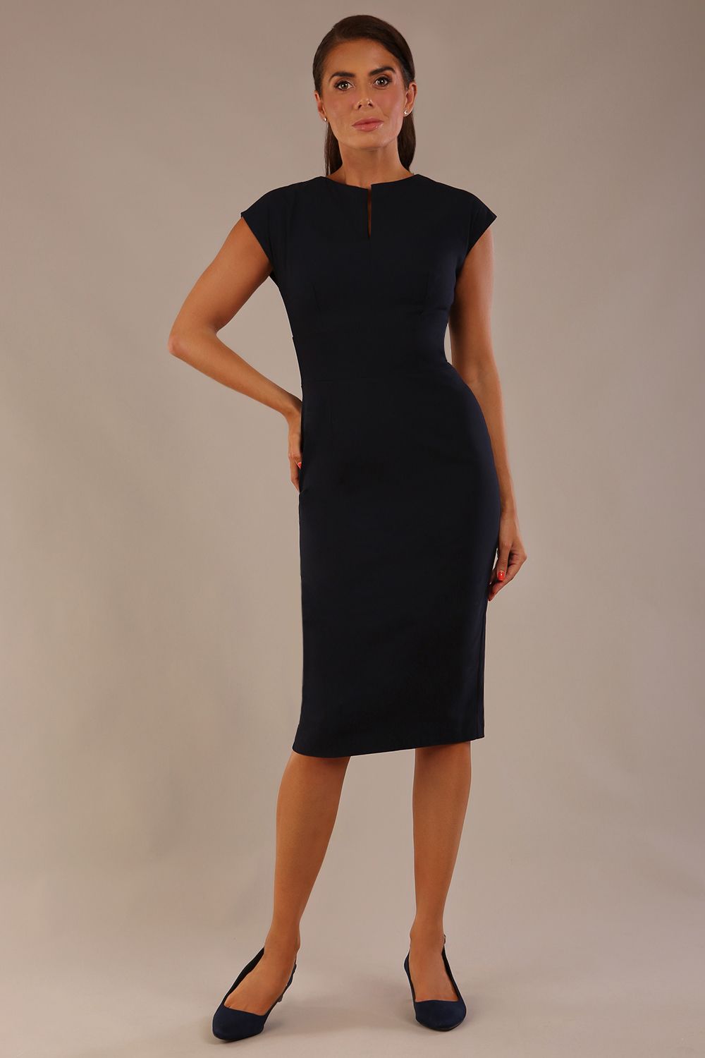 brunette model is wearing a diva catwalk Claire Cap Sleeve Pencil Dress cap sleeve with round neckline with v-slit and knee length indark navy colour front