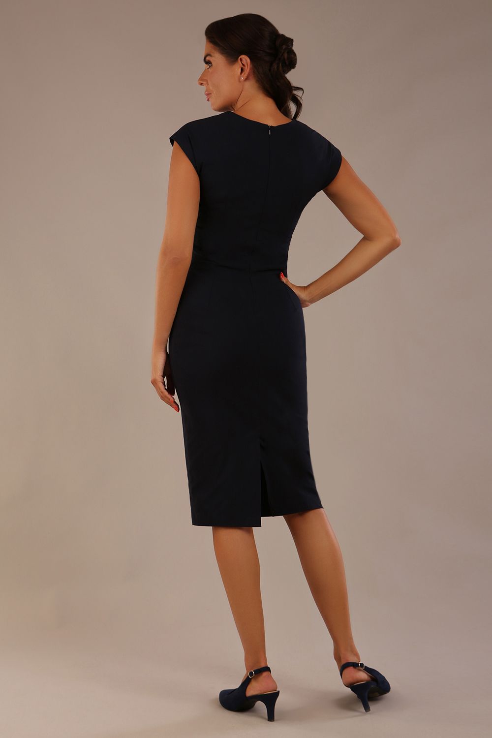 brunette model is wearing a diva catwalk Claire Cap Sleeve Pencil Dress cap sleeve with round neckline with v-slit and knee length indark navy colour back