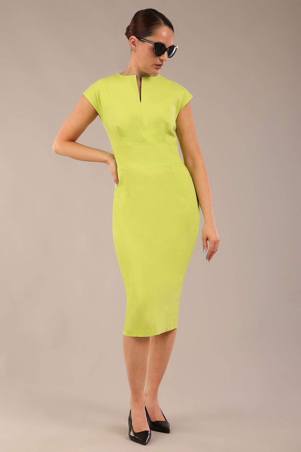 model wearing a diva catwalk Claire Cap Sleeve Pencil Dress cap sleeve with round neckline with v-slit and knee length in lime green colour front