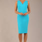 brunette model is wearing a diva catwalk Carrie Pencil Wiggle Dress sleeveless v neck front and back knee length in azure blue colour front image
