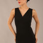 brunette model is wearing a diva catwalk Carrie Pencil Wiggle Dress sleeveless v neck front and back knee length in black colour front image with sunglasses