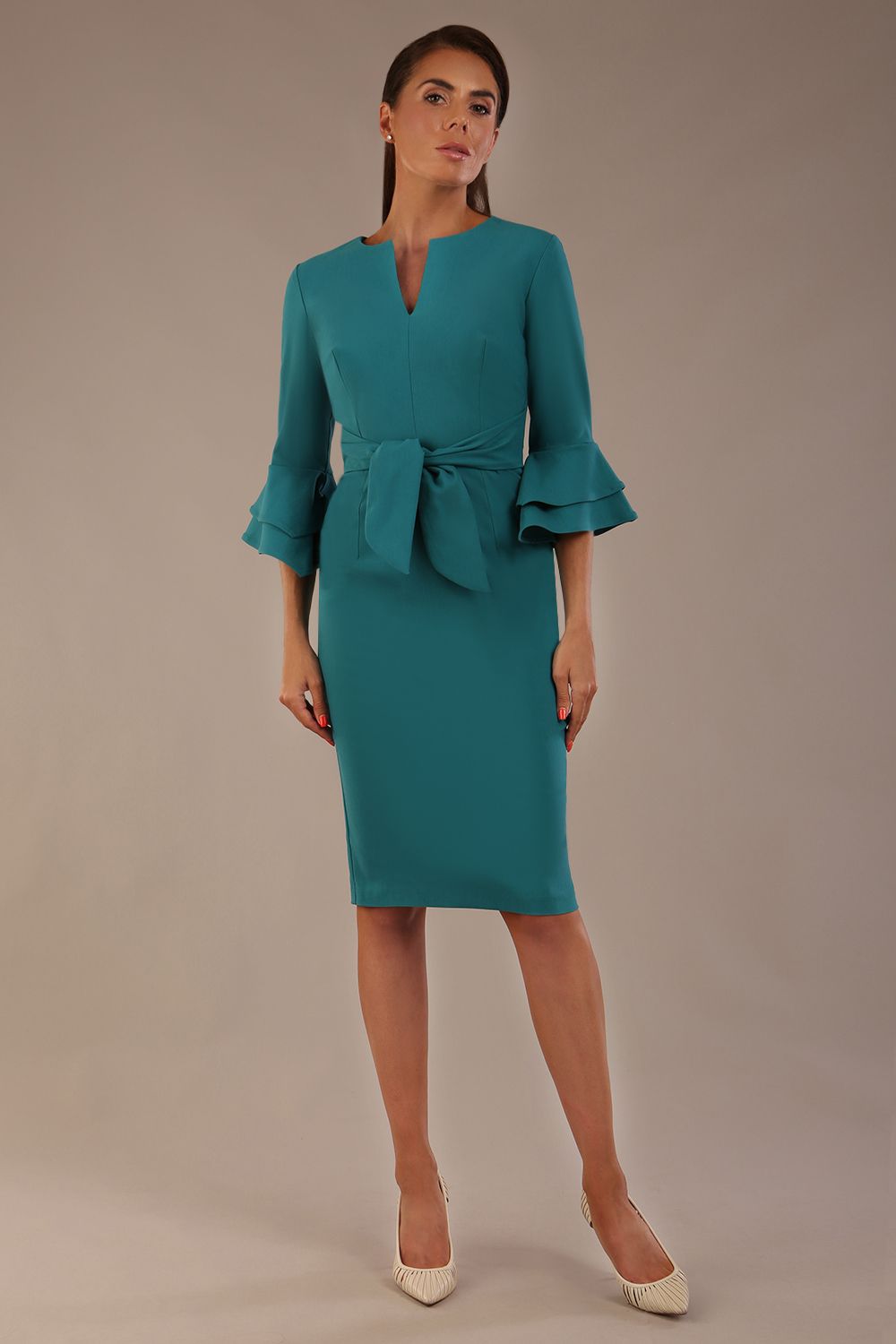 brunette model is wearing a diva catwalk Hobson ruffled sleeves Pencil Dress with tie waistband knee length in Teal Green colour front