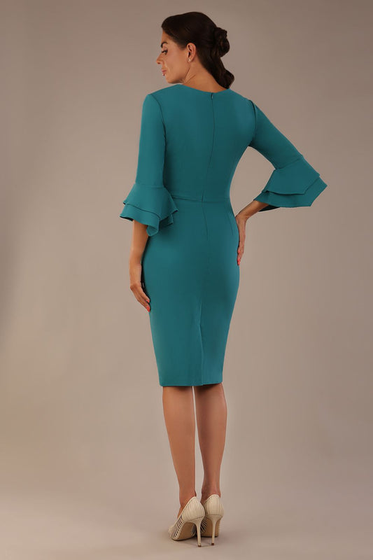 brunette model is wearing a diva catwalk Hobson ruffled sleeves Pencil Dress with tie waistband knee length in Teal Green colour back